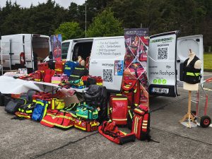 Elite Bags and Flashpoint Systems booth at the National Rescue & CPR Challenge 2025 with emergency backpacks, medical bags, and training mannequin.