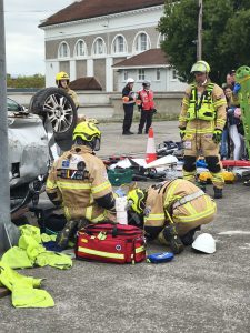 Firefighters performing a rescue intervention with an overturned car, using an Elite Bags medical bag during a simulation at the National Rescue & CPR Challenge 2025.